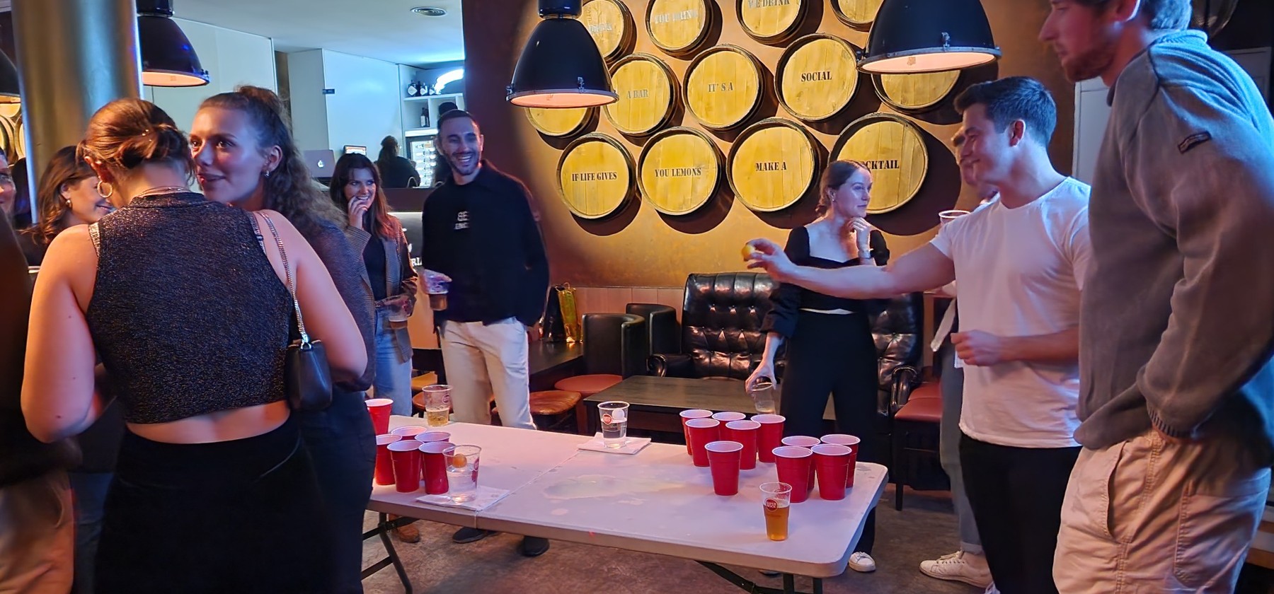 Players enjoying beer pong at The Spot Lisboa